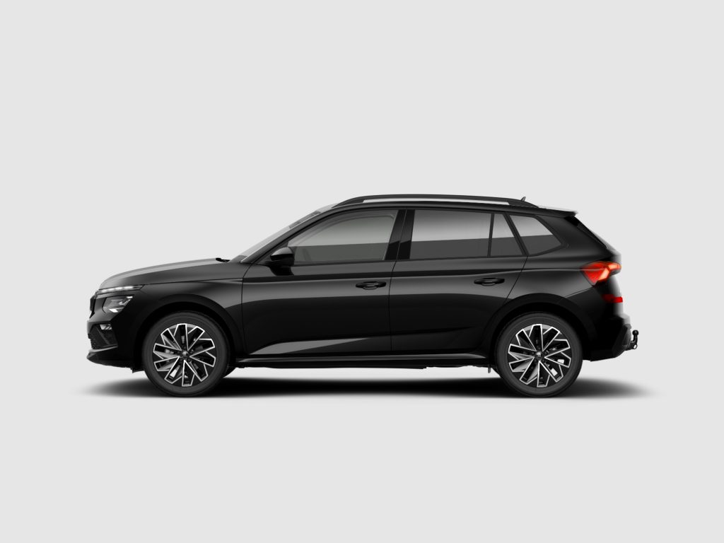 Side view of a black SUV with roof rails, cropped at the bottom, showing stylish alloy wheels and a red taillight on a light gray background
