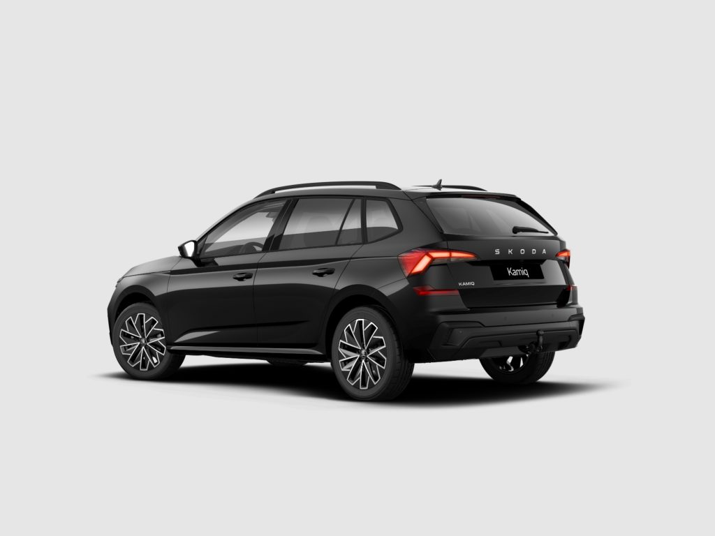 Rear three-quarter view of a black Skoda Kamiq SUV with visible CKD badge and alloy wheels, on a light gray background.