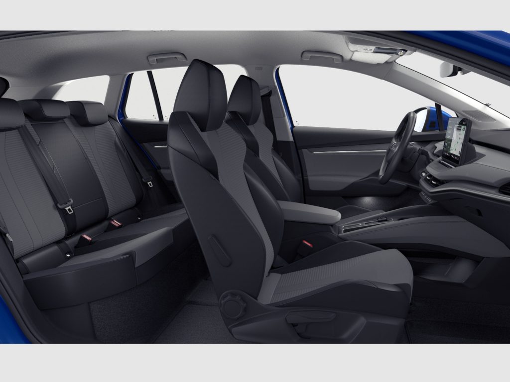 Modern car interior with black fabric seats, front captain chairs, and a rear bench; driver-side dashboard and large touchscreen near the center.