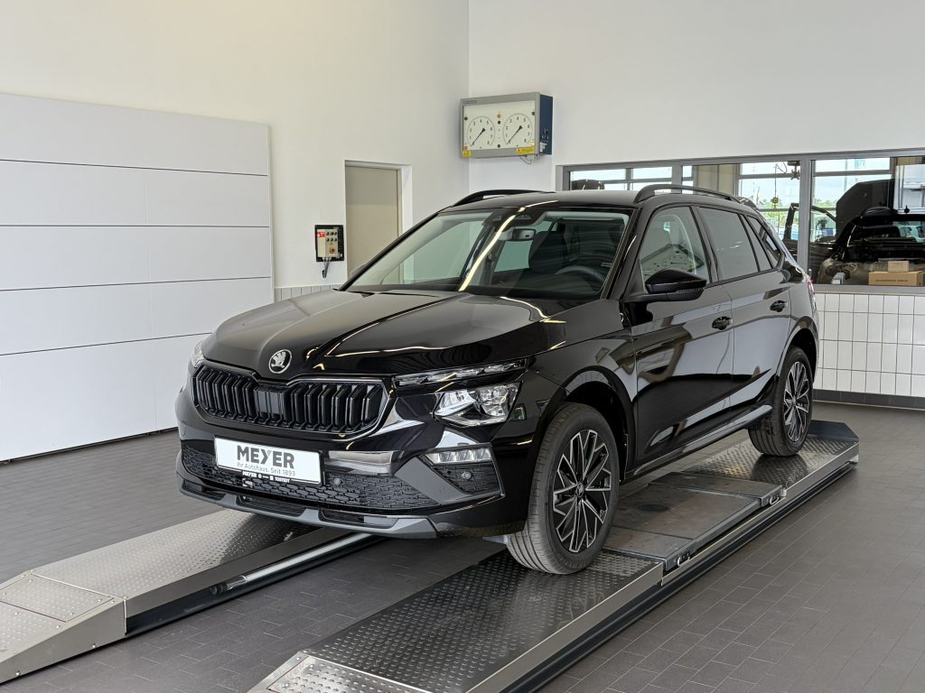 Black SUV on a car dyno roller inside a showroom, front view with dealer plates visible