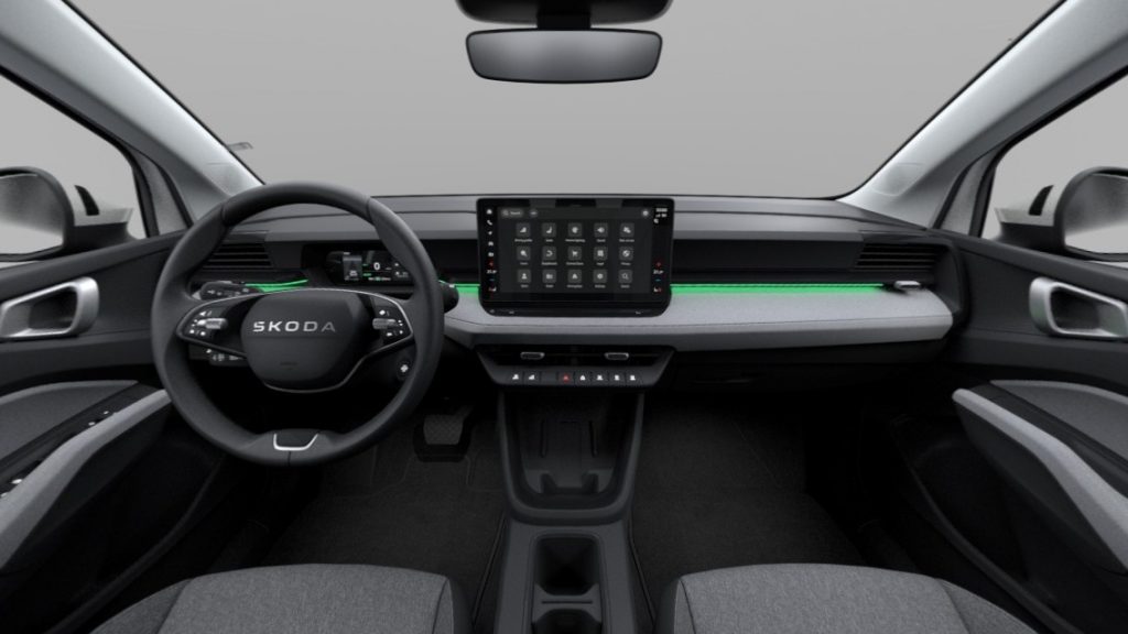 Skoda car interior displaying a large central touchscreen and green ambient lighting on the dashboard.
