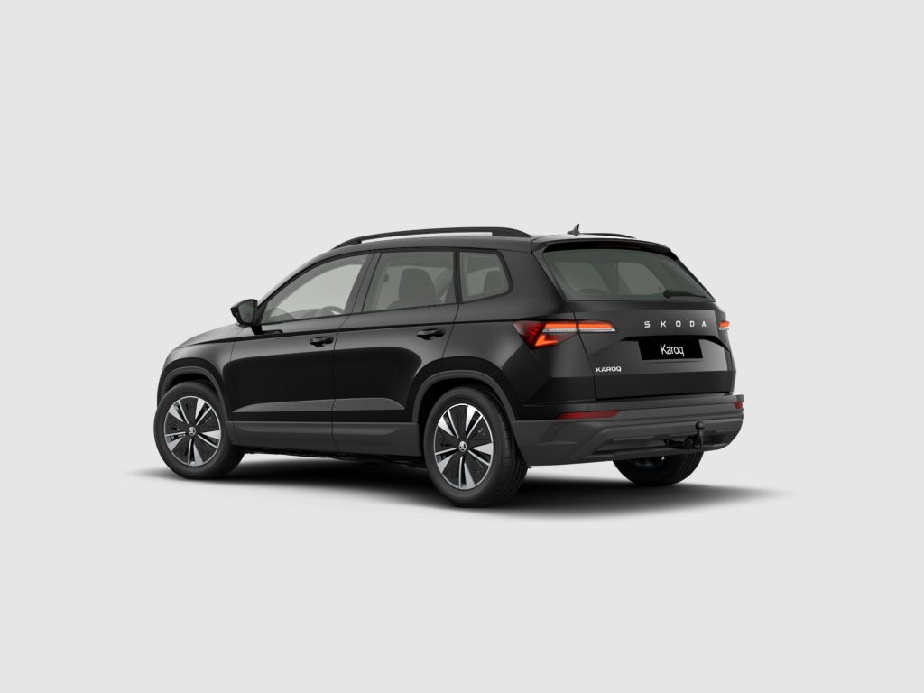 Rear three-quarter view of a black Skoda Karoq SUV against a plain light background, showing the tailgate with Skoda branding and alloy wheels.