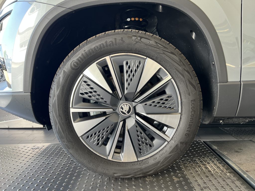 Close-up of a car wheel with a Continental tire and a black wheel well, showing the alloy rim and Volkswagen center cap.