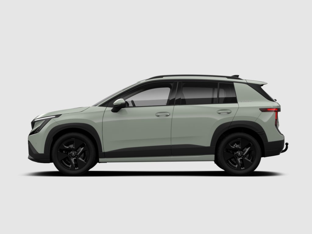 Partial side view of a light gray Skoda SUV, showing doors, windows, roof rails, and black wheels against a plain background.
