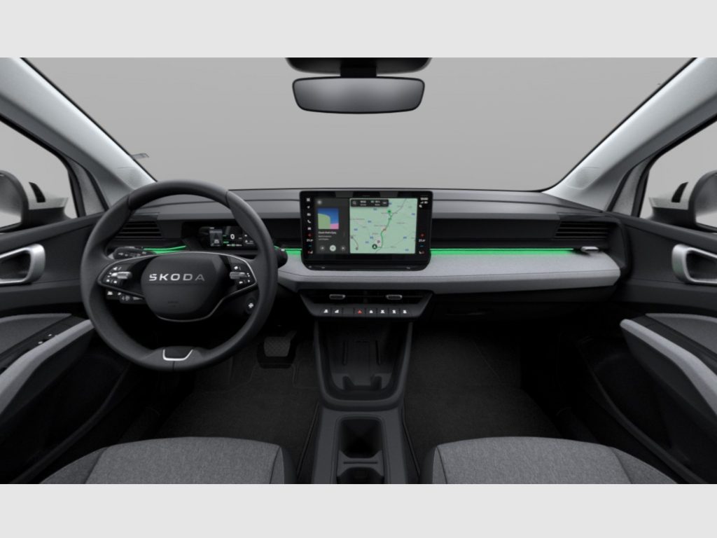 Interior view of a car cockpit with a steering wheel on the left and a central touchscreen displaying a navigation map
