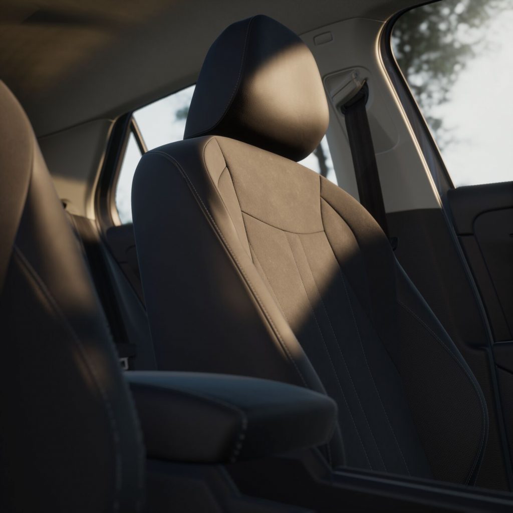 Close-up of a car's front seat and headrest in a sunlit interior.