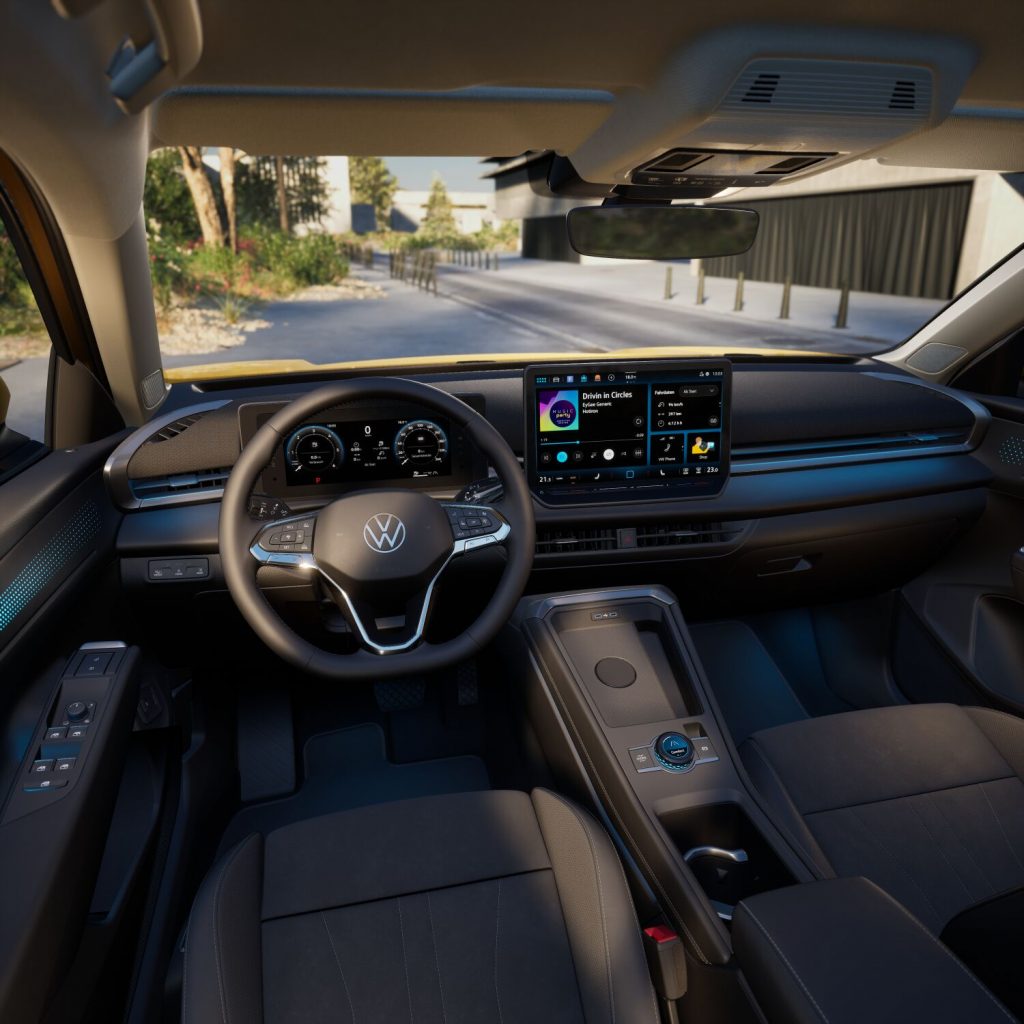 Interior of a modern car cockpit showing a digital instrument cluster, a large central touchscreen, and a stylish steering wheel with VW logo (note: car brand visible should be accurate; replace if needed). Sue: Wait this might be VW logo; the image shows VW emblem on steering wheel. Alt text: 'Modern car interior with digital gauge cluster, large infotainment screen, and a multi‑function steering wheel.'